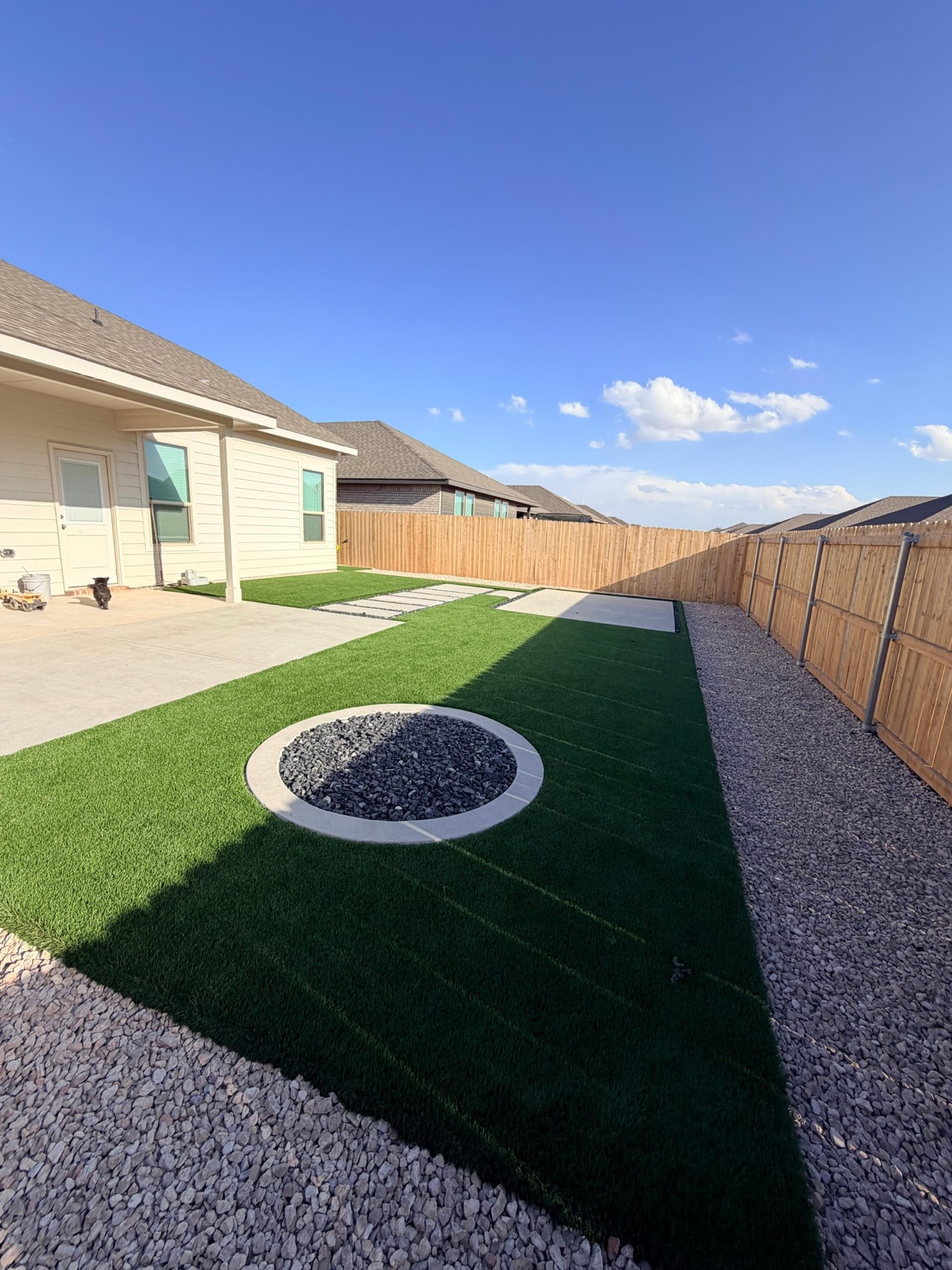 Backyard transformed with turf and firepit